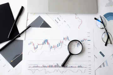 Relatórios financeiros analisados com lupa